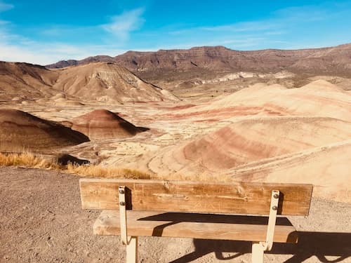 Vast land of sandy hills and wooden bench